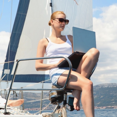 woman-working-with-a-laptop-on-a-boat Working with a laptop on a boat